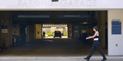 A woman walks past the entrance to a downtown Orlando parking garage.
